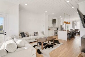 Ein modernes Wohnzimmer mit einer Couch, einem Couchtisch und einem Kuhfellteppich.