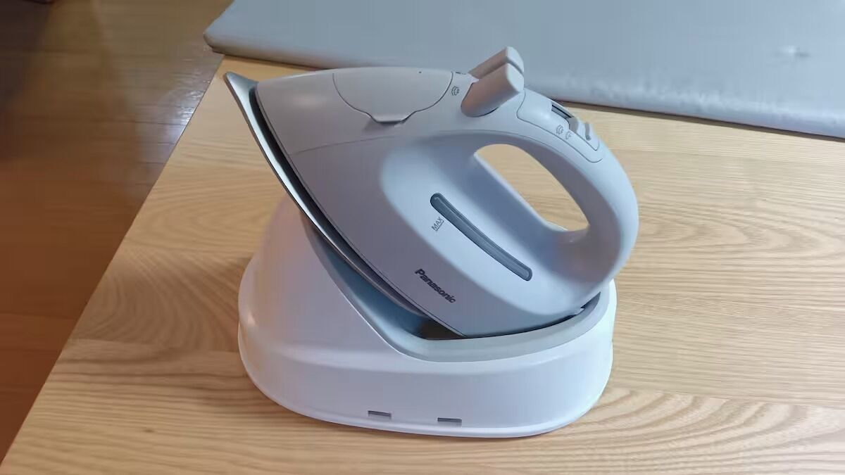 A Panasonic iron on a wooden table.