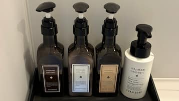 Four bottles of Hajimari Organic products on a shelf.