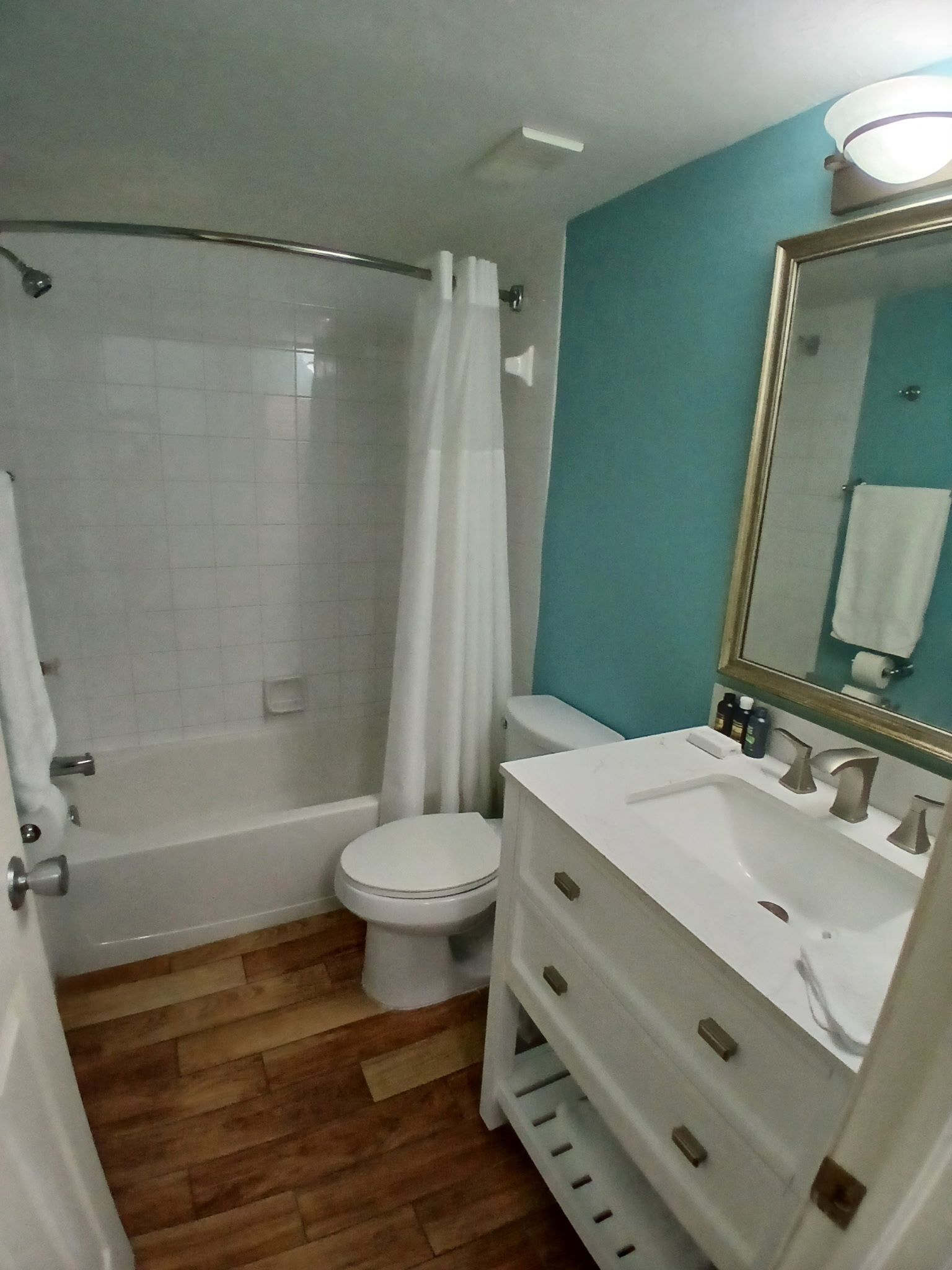 A bathroom with a bathtub, toilet, and sink.