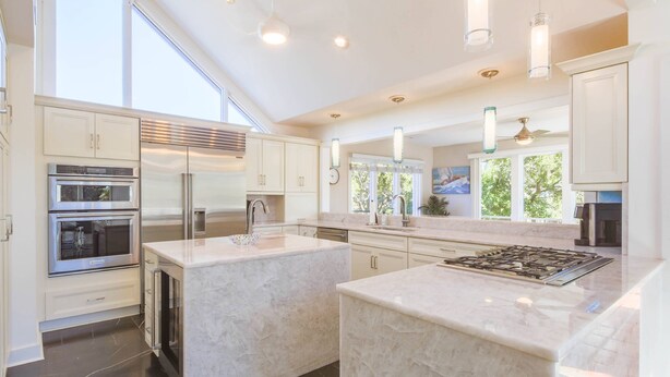 A modern kitchen with a large island, stainless steel appliances, and ample natural light. - Private Access to Beach Boardwalk 4; FREE Amenity Card Privileges; Back Deck w/ Private Hot Tub! (Seabrook Island)