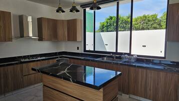 Microondas, placa de cocina, cafetera o tetera y utensilios de cocina