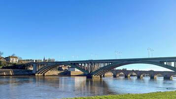 A bridge over a river with a clear sky.