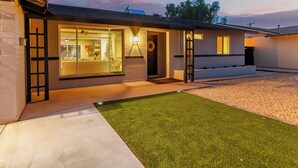 A modern house with a well-maintained lawn, a garage, and a visible driveway. - Old Town Dream- Pool, Hot Tub, Firepit, Foosball, Cornhole, and Mini Golf (Scottsdale)