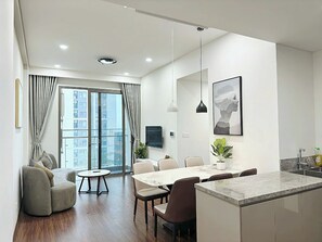 A modern apartment with a dining area, a kitchen, and a living room. - Vinhomes Ocean Park 1 Gia Lâm Apartment (Hanoi)