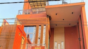 A multi-story building with a sign reading "Amrit Residency." It features a staircase, a gated entrance, and a balcony. - Amrit Residency (Vrindavan)