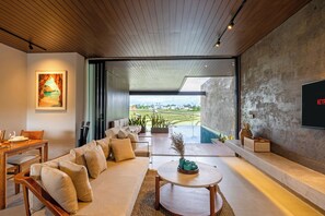 A modern living room with a sofa, coffee table, and artwork on the wall. - Nava Tamora by Betterplace (Canggu)