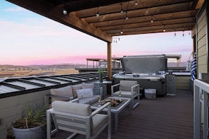 A rooftop patio with outdoor furniture, a grill, and a view of the cityscape. - Rooftop Deck w/ Hot Tub | Near Dining & Ski Slopes | The Lookout by AvantStay (Park City)