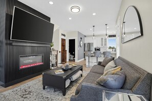 A modern living room with a fireplace, a sofa, and a coffee table. - Rooftop Deck w/ Hot Tub | Near Dining & Ski Slopes | The Lookout by AvantStay (Park City)