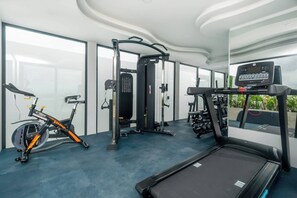 A gym with a treadmill, exercise bike, and weight machines. - Rooftop pool studio | steps to Coco Beach (Playa del Carmen)