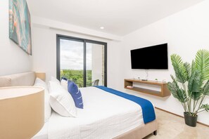 Une chambre à coucher moderne avec un lit, une télévision, une fenêtre et une plante.