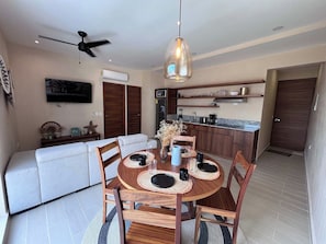 A modern kitchen with wooden cabinets, a built-in oven, and a microwave. - Beachside escape w/ rooftop pool access (Playa del Carmen)