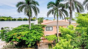 A coastal property with a house, palm trees, and a view of the sea. - 6BR villa w/ pool, BBQ & backyard (Playa del Carmen)