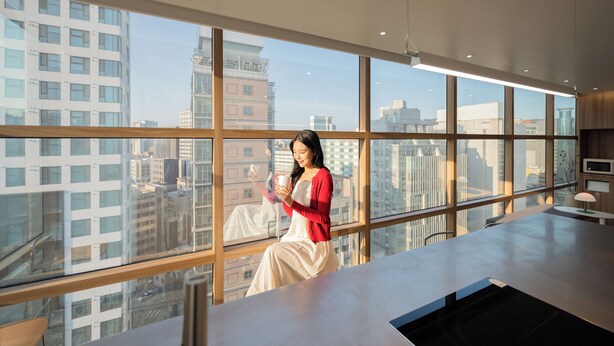 A modern interior with large windows offering a city view. - Loft13 Hostel (Seoul)