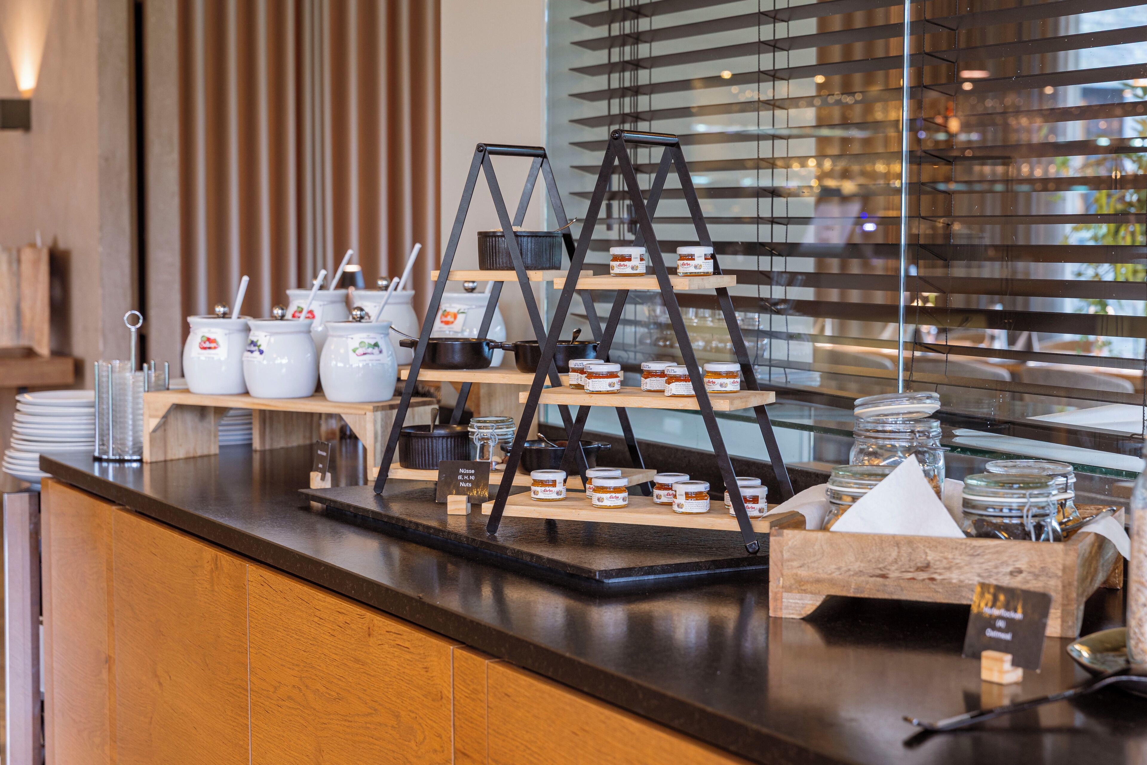 A breakfast buffet with various food items and condiments displayed on shelves and counters.
