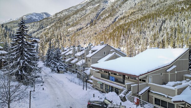 A snow-covered mountain town with multi-story buildings, a ski lift, and a clear sky. - Nestle Inn Hideaway - Toby Creek Lodge Unit 213 (Area F (Columbia Lake/Windermere Lake))