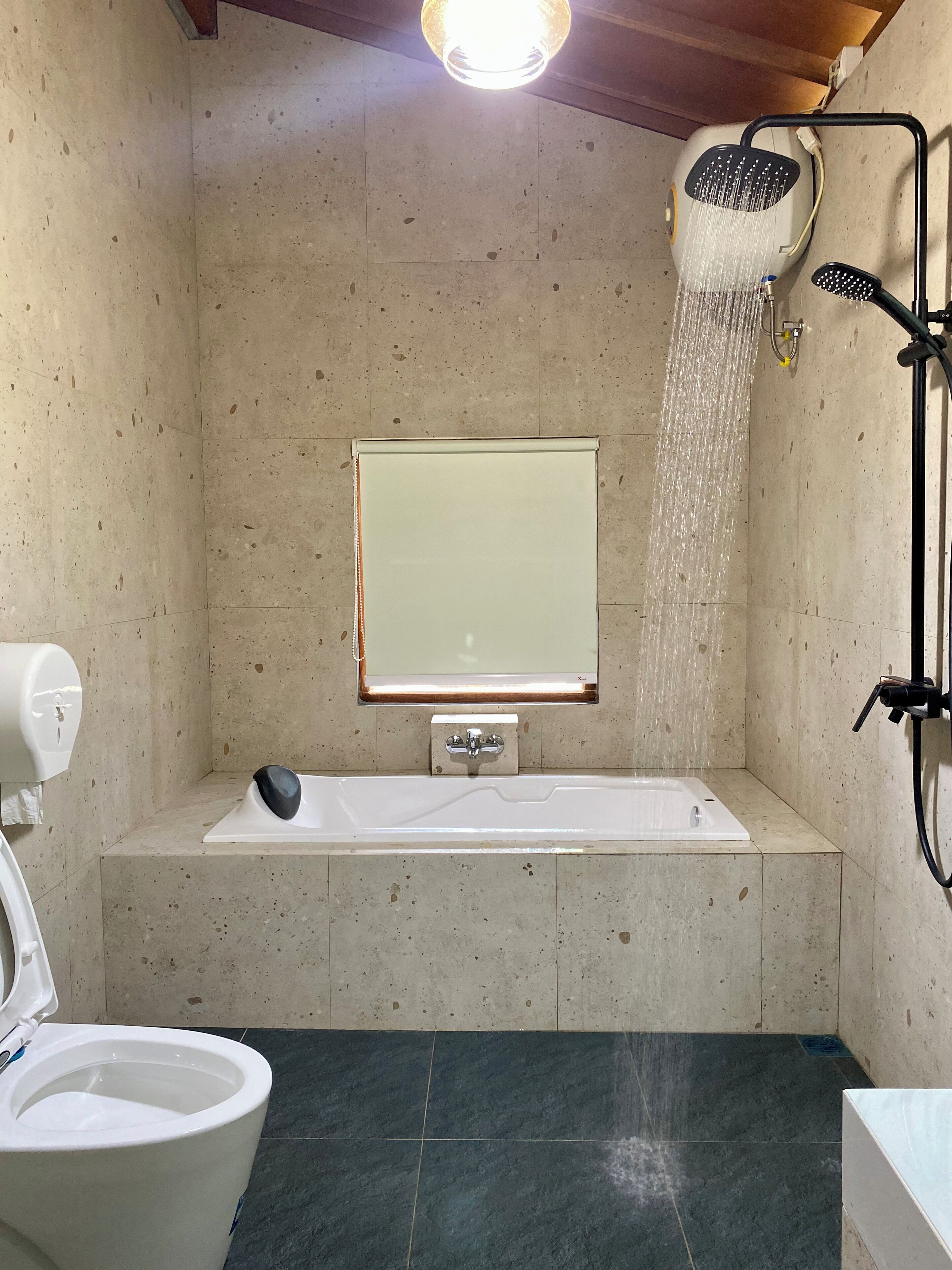A bathroom with a bathtub, a toilet, and a shower.