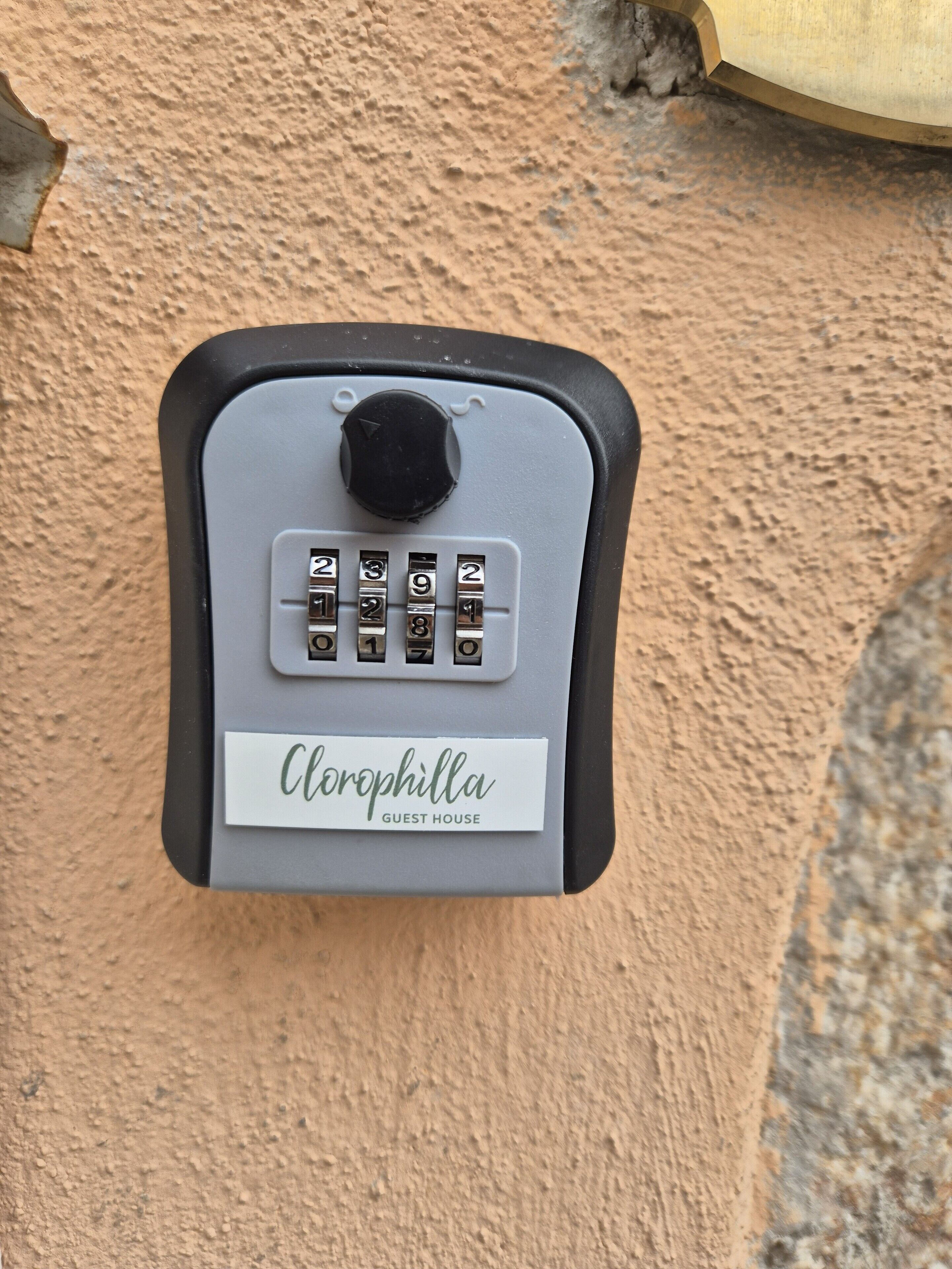 A keypad lock with a label reading "Clorophilla Guest House".