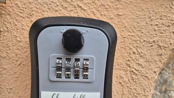 A keypad lock with a label reading "Clorophilla Guest House".