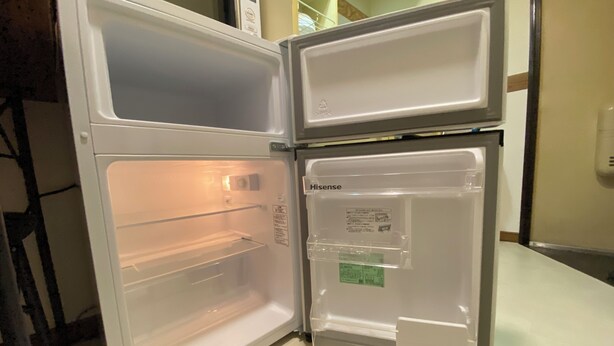 An open refrigerator with a Hisense brand label, a transparent door, and a freezer compartment. - 30sec walk to Tsutenkaku/1 stop to Namba Sta./AH68 (Ebisu Higashi Naniwa-Ward,Osaka City)
