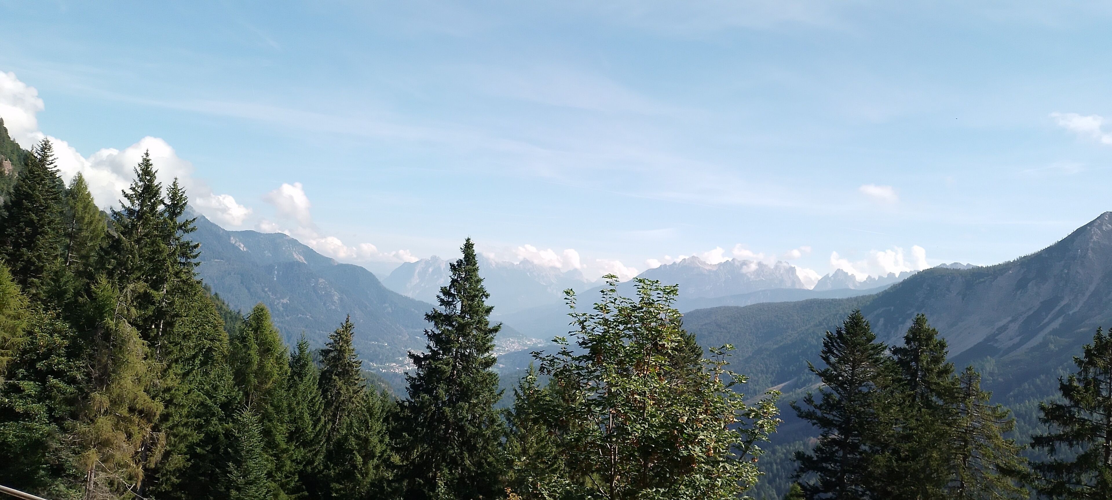 Un paysage montagneux, avec de vastes forêts et un ciel dégagé.