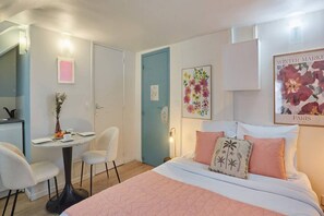 Desk, iron/ironing board, bed sheets