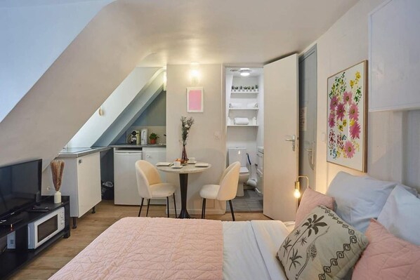 Desk, iron/ironing board, bed sheets