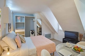 Desk, iron/ironing board, bed sheets