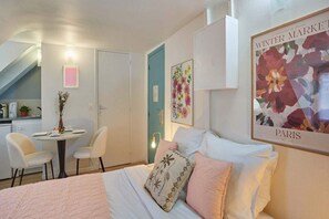 Desk, iron/ironing board, bed sheets