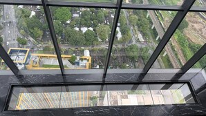 A high-rise building with a view of a cityscape through large windows. - Circle Living Skyline Residence (Bangkok)