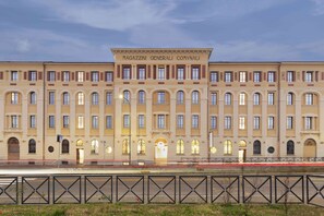 Un edificio grande e histórico con varias ventanas y una entrada central.