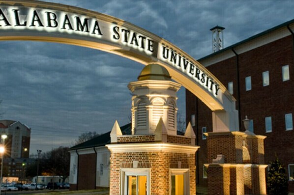 A brick building with a large archway displaying "ALABAMA STATE UNIVERSITY".