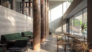 A spacious indoor area with high ceilings, large windows, and modern seating arrangements. - Árbol Moganshan Yucun (Huzhou)