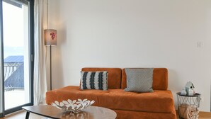 A modern living room with a sofa, a coffee table, and a lamp. - La Grangette Wifi Parking Terrace (Cruet)