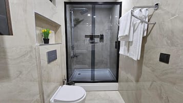 Deluxe Quadruple Room, Patio, City View | Bathroom | Shower, hair dryer, towels, soap