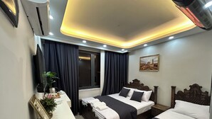 A hotel room with two beds, a desk, and a window. - Hasan Pasa Konagi (Mardin)