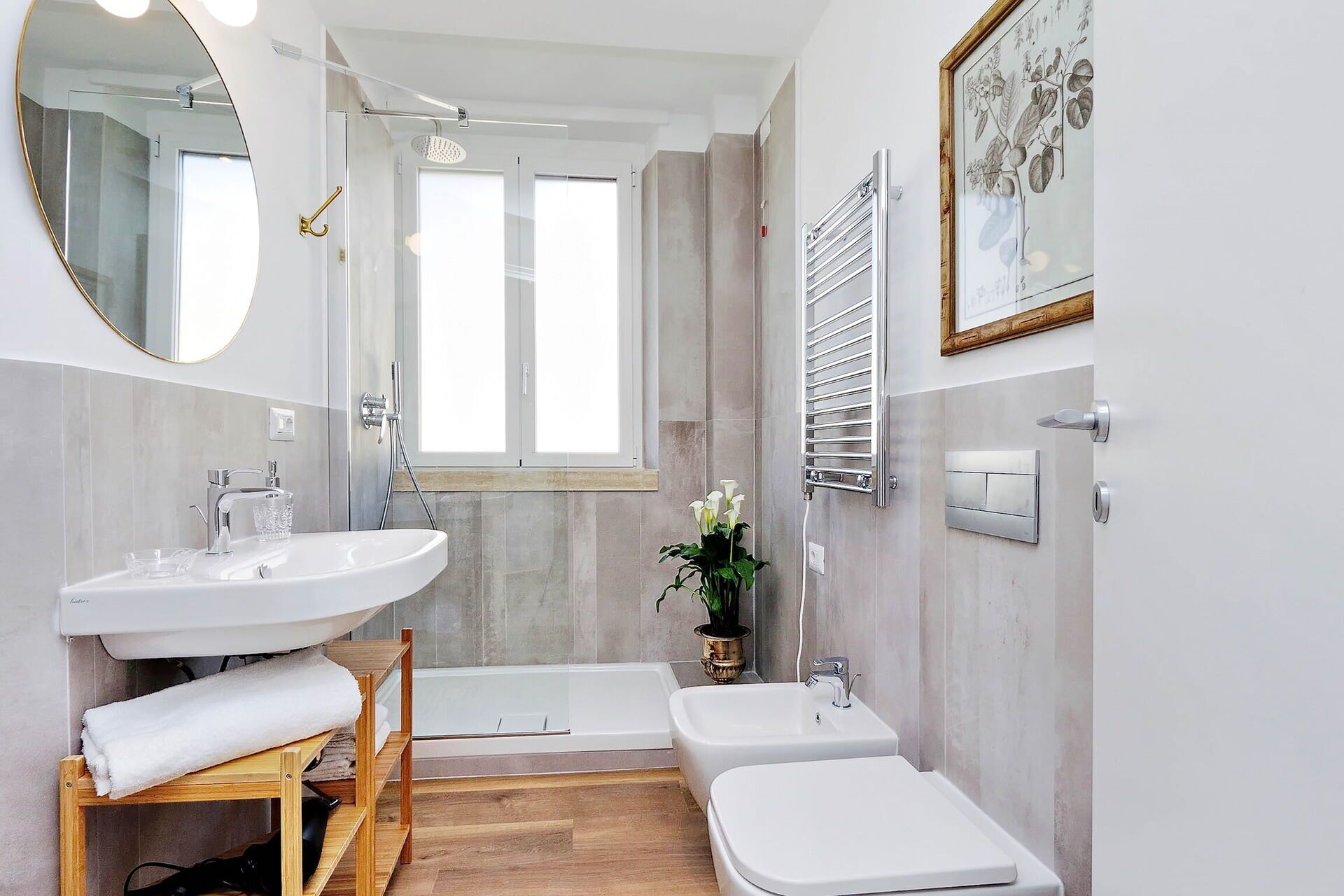 A modern bathroom with a large mirror, two sinks, a bathtub, and a shower.
