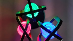 Three illuminated spherical objects with cross-like structures. - Hotel Laxmi villa (Ujjain)