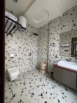 A bathroom with a freestanding bathtub, a sink, and a toilet.
