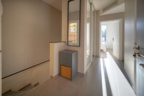A hallway with a small cabinet, a mirror, and a door leading to another room. - 3 Bedroom Terrace and 1 Bedroom Studio A4B026 (Cannes)