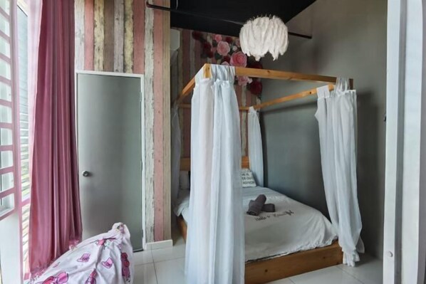 A room with a bed, curtains, a door, and a window. - Setia Tri-Suite(7) by Homey Planet (Bayan Lepas)