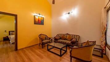 Premium Cottage | Living area | 32-inch TV with cable channels