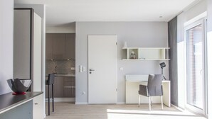 A modern apartment with a kitchen, dining area, and a large window. - Refugium 2 (Emsdetten)