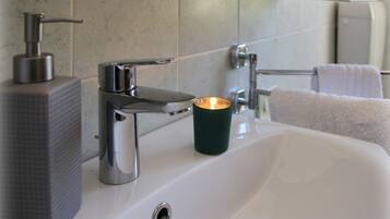 Chuveiro, secador de cabelo, bidê, toalhas de banho