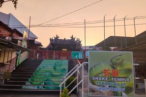 A temple entrance with a staircase leading up to a traditional roofed structure. - The CEO Suite7 by Homey Planet (Bayan Lepas)