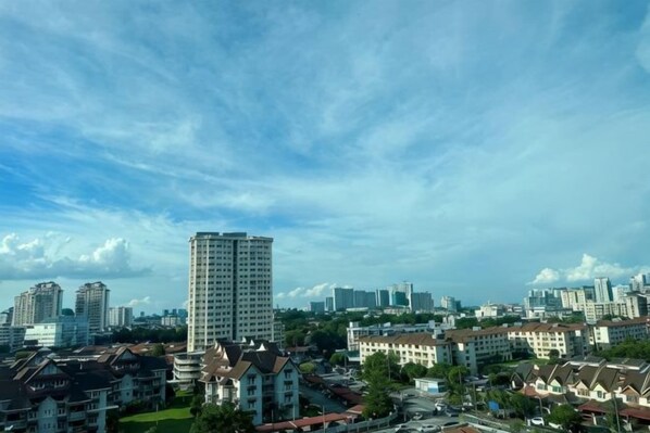 A cityscape with residential buildings and a tall skyscraper. - The CEO Suite7 by Homey Planet (Bayan Lepas)