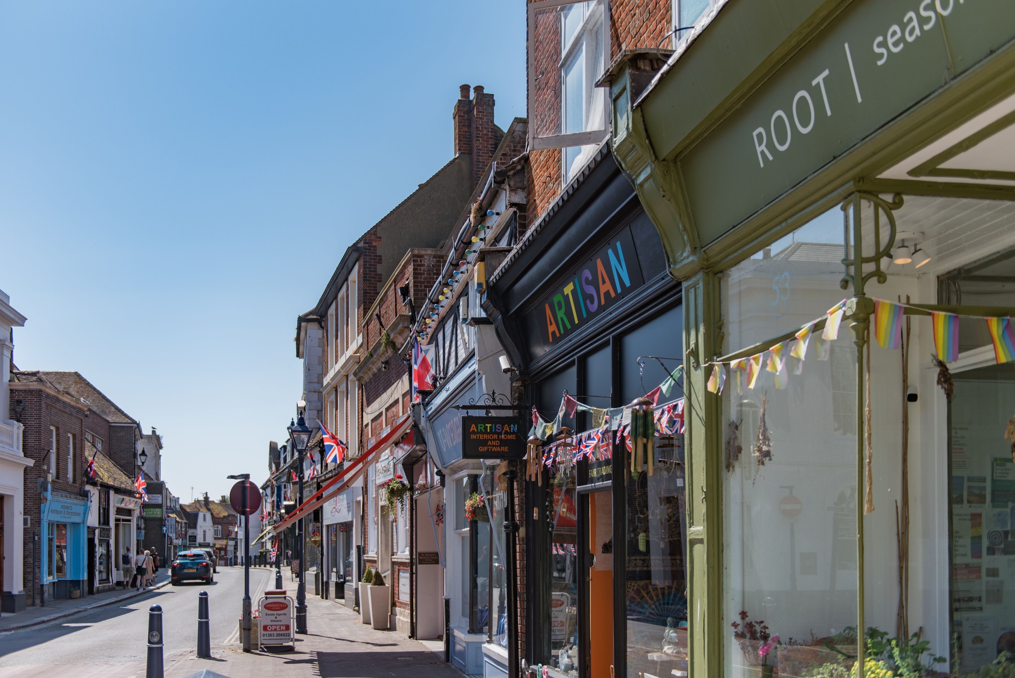 A street view with shops, including a visible storefront with the sign 'ARTISAN'.