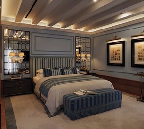 A bedroom with a large bed, bedside tables, a nightstand, a mirror, and wall-mounted lighting. - Locanda Cipriani Torcello (Venice)