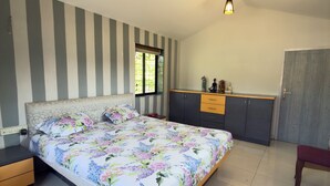 A bedroom with a bed, a nightstand, a dresser, a wardrobe, a ceiling fan, and a window. - LONAVALA TURGARLI-ESCAPE TO BYGONE ERAA HOME WITH SOUL (Lonavala)