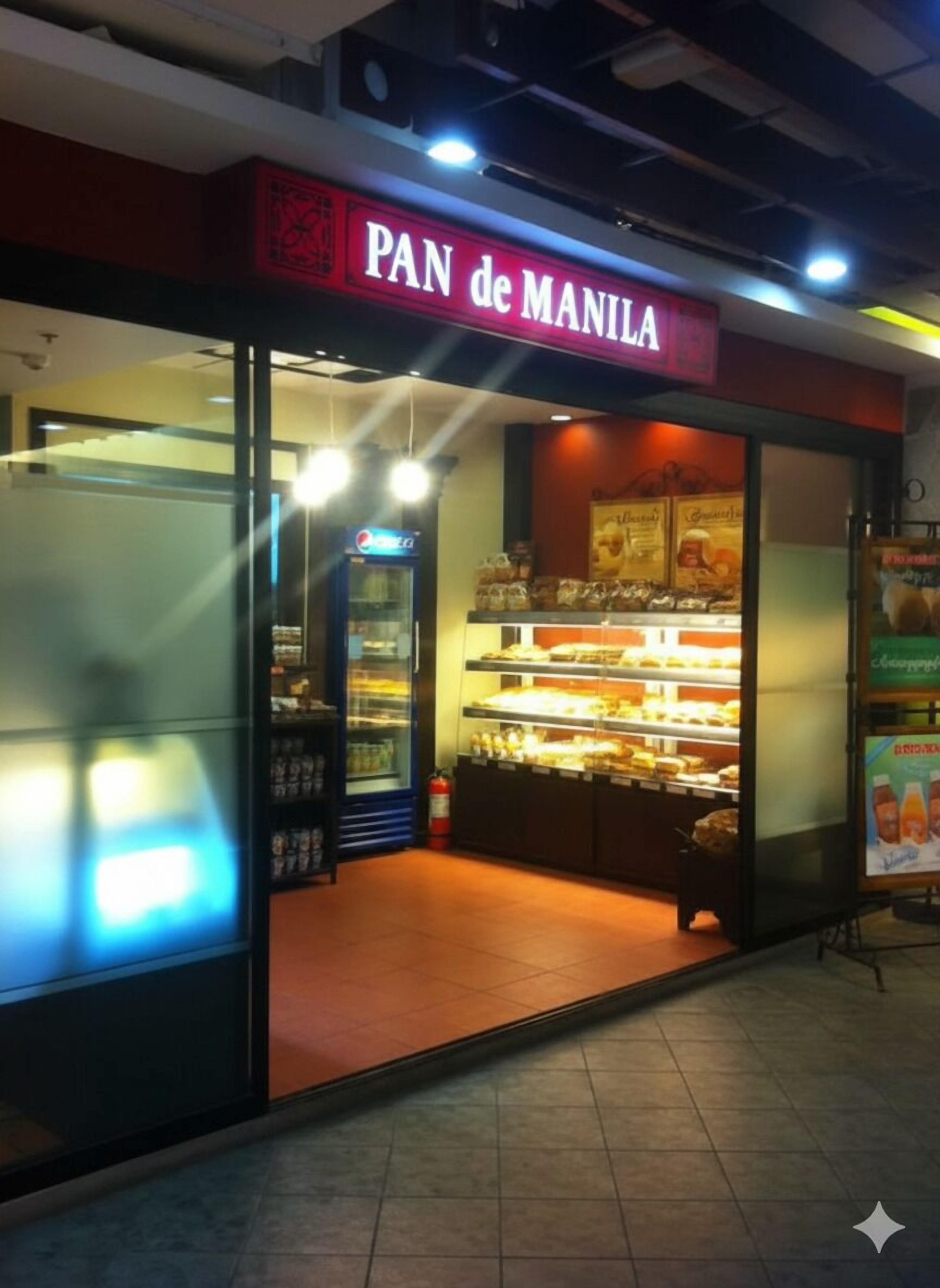 A bakery named "PAN de MANILA" with a display case of baked goods and a Pepsi refrigerator.